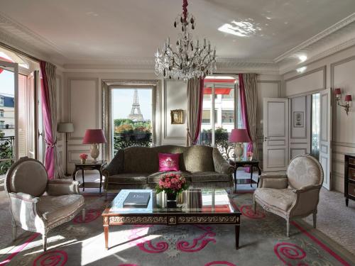 a living room with a couch and a table at Hôtel Plaza Athénée - Dorchester Collection in Paris