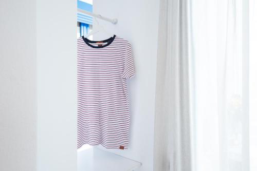 a black and white striped dress hanging on a rack at Anna Plakias Apartments in Plakias