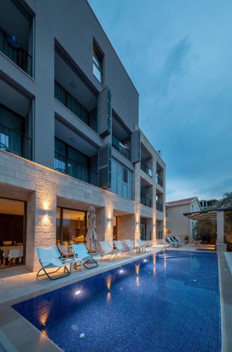 a swimming pool in front of a building at Hotel Eleven in Petrovac na Moru
