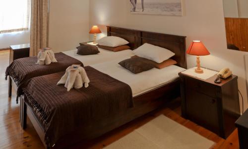 a bedroom with two beds with towels on them at Hotel Prinzessin Rupprecht in Swakopmund