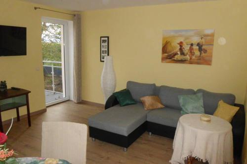 a living room with a couch and a table at Sinnes Wandel Hof Serka in Grimma