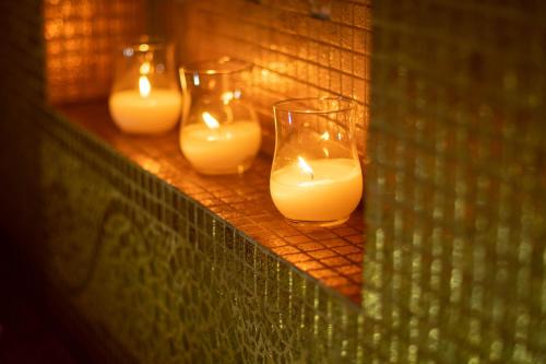 a group of candles inront of a mirror at Above Blue Suites in Imerovigli