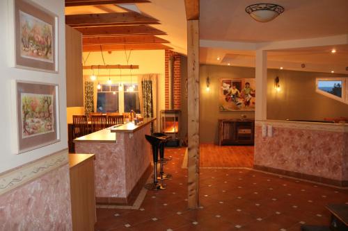 a lobby with a bar in a restaurant at Helle, offene Dachgeschosswohnung mit Terrasse in Oberloisdorf