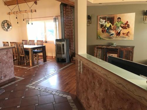 a living room with a counter and a dining room at Helle, offene Dachgeschosswohnung mit Terrasse in Oberloisdorf