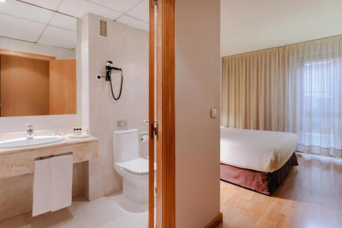 a bathroom with a sink, toilet and bathtub at Hesperia Zaragoza Centro in Zaragoza