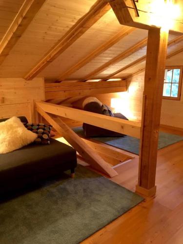 a room with a bunk bed in a cabin at B&B Casa PerAria in Paluzza