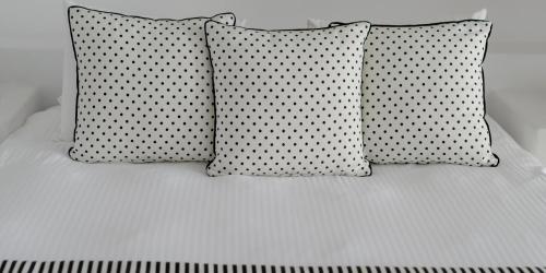 two polka dotted pillows on top of a bed at Above Blue Suites in Imerovigli