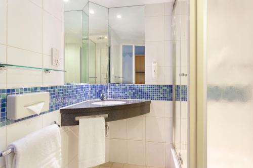 a bathroom with a sink and a shower at Holiday Inn Express Earls Court, an IHG Hotel in London