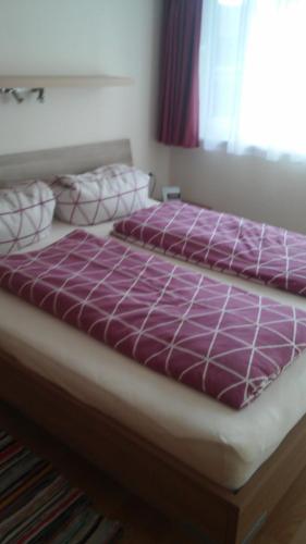 two beds sitting next to each other in a bedroom at Ferienwohnung Kogler in Waidring