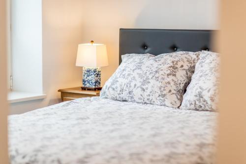 a bedroom with a bed and a lamp on a table at Space Apartments Szczecin in Szczecin