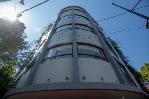 a tall building with the sun in the background at V65 Mx in Mexico City