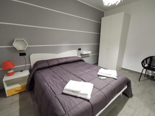 a bedroom with a bed with two towels on it at IL FEUDO in Sellia Marina