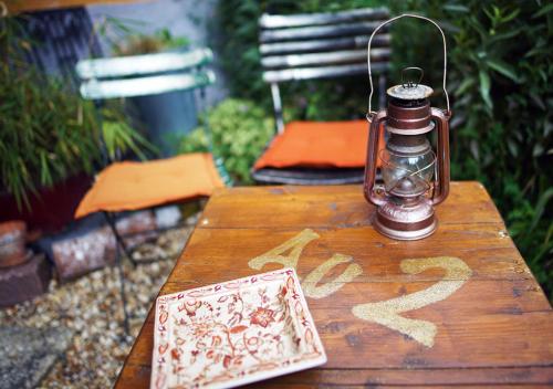 a wooden table with a lantern on top of it at Au2 Maison d'Hôtes - Guest House Au2 in Muidorge