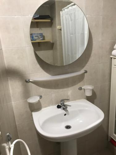 bilo Crocetta في تورينو: حمام مع حوض أبيض ومرآة