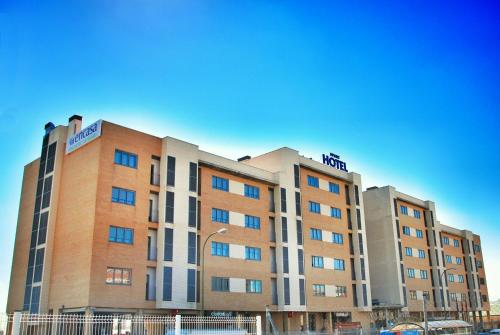 a building with a hotel on top of it at Aparthotel Encasa in Madrid