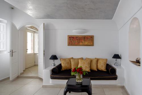 a living room with a couch and a table at Above Blue Suites in Imerovigli