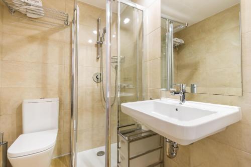 a bathroom with a sink and a toilet and a shower at Eix Alcudia Hotel Adults Only in Port d'Alcudia