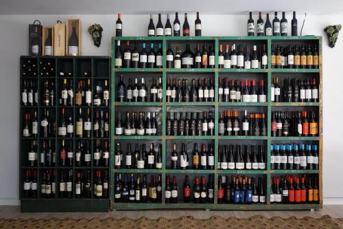a display case filled with lots of bottles of wine at Vale do Gaio Hotel in Torrão