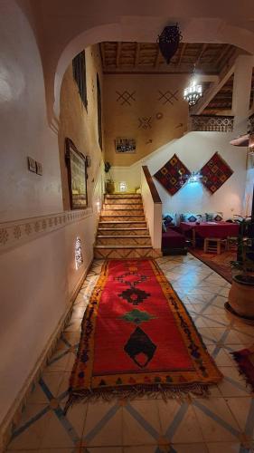 a hallway with a red rug on the floor at Auberge Tissadrine in Akhendachou nʼAït Ouffi