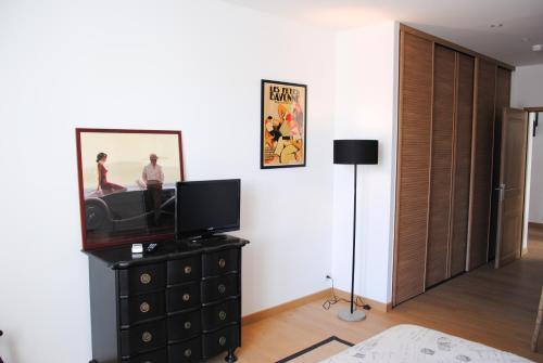 a living room with a television on a dresser at G-63 - Appartement de standing en plein coeur d'Hossegor in Soorts-Hossegor