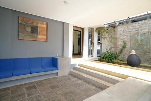 a living room with a blue couch and a wall at Mount Marina Villas 12 in Galle