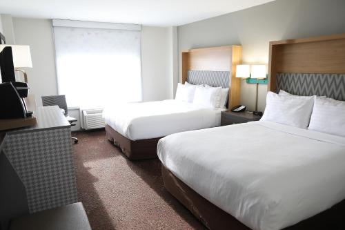 a hotel room with two beds and a window at Holiday Inn O'Hare Area by IHG in Rosemont