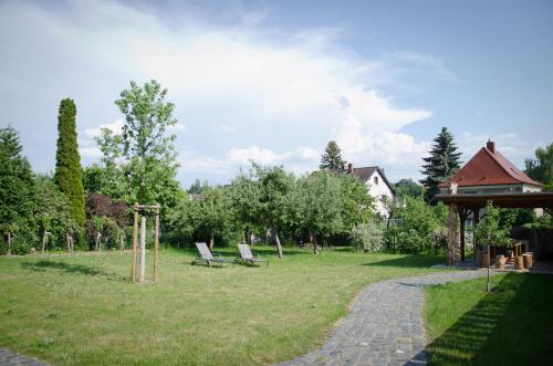 a park with two chairs and a gazebo at Villa Kreisel in Dresden
