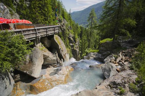 a train on a bridge over a river at Apartment Lognan 1 - A Chamonix Mont Blanc Haven in Chamonix-Mont-Blanc