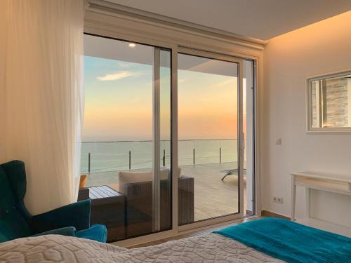 a bedroom with a view of the ocean at Holiday Apartment Ocean View in Ribeira Brava