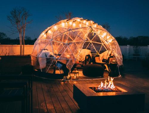 two domes covered in lights with a fire pit at The Menhaden Hotel in Greenport