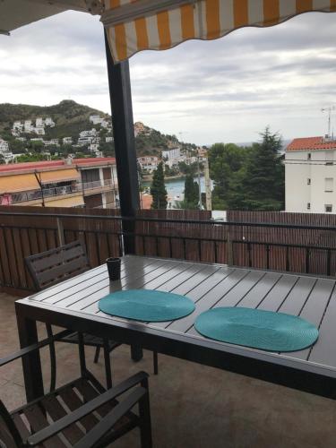 a table and chairs on a deck with a view at Apartamiento canyelles in Roses