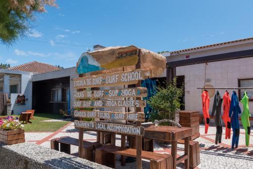 a sign for a surf shop in front of a building at Ticket2Surf in Palheiros da Tocha
