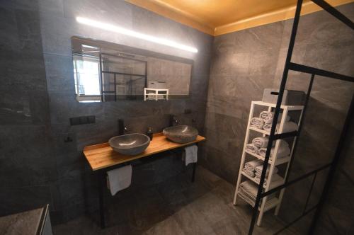 a bathroom with two sinks and a mirror at Bergchalet Hinterstoder in Hinterstoder