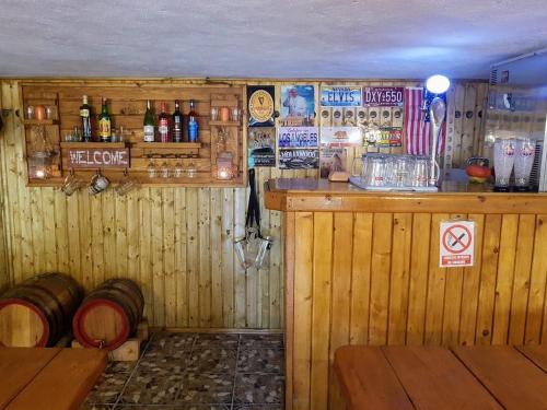 a bar in a pub with a lot of alcohol at Pensiunea Agroturistică Piscul Soarelui in Cîmpulung
