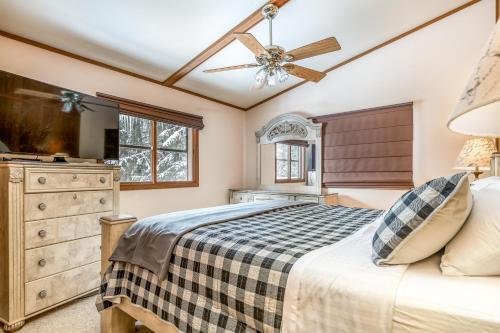 a bedroom with a bed and a ceiling fan at Vance Bay Getaway in Manitowish Waters