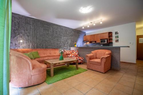 a living room with a couch and two chairs and a table at Fatrapark 2 Apartments HRABOVO - Hlavná recepcia in Ružomberok