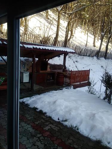 a pile of snow in front of a bench at Casa Ozon in Vulcan