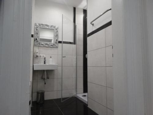 a white bathroom with a sink and a mirror at Füssen Apartments - Center Apartments in Füssen