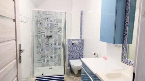 a bathroom with a shower and a toilet and a sink at Apartament z widokiem. in Karpacz