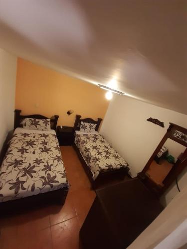 a bedroom with two beds in a room at Hotel y Restaurante Colonial Popayan in Popayan