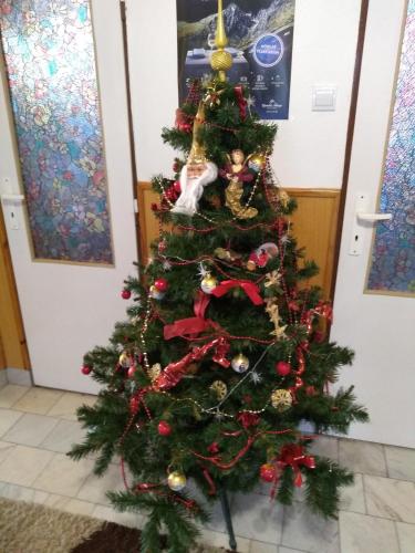 a christmas tree with ornaments on it at Vysoké Tatry Gerlaška in Gerlachov