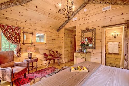 a log cabin bedroom with a bed and a chair at Lake Rabun Hotel in Lakemont