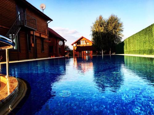a large blue swimming pool next to a building at GorodOk in Migovo