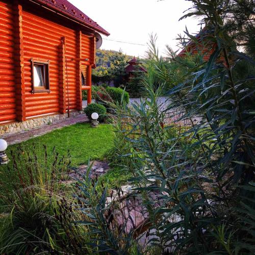 an orange house with a garden in front of it at GorodOk in Migovo