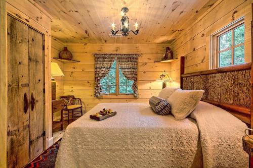 a bedroom with a bed in a log cabin at Lake Rabun Hotel in Lakemont