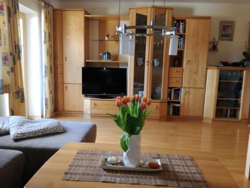a living room with a vase of flowers on a table at Ferienwohnung Sagmeister Wirtgut St. Andrä in Sankt Andrä im Lungau