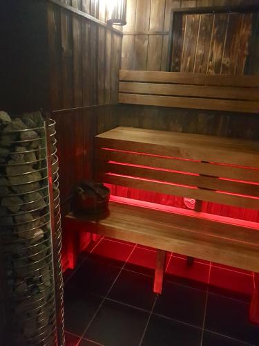a wooden bench in a room with wooden walls at Aparthotel Narciarska 2 in Korbielów