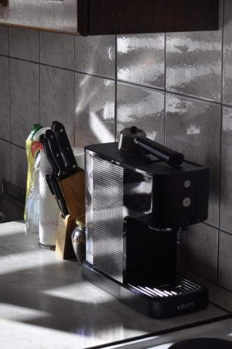 a black coffee maker sitting on a kitchen counter at Apartman Jonjić in Kupres