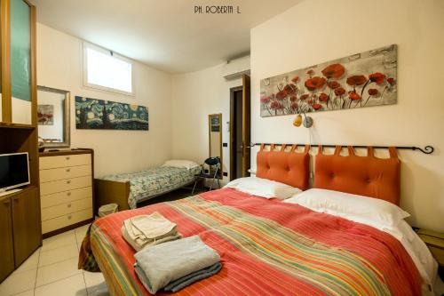a bedroom with a large bed and a television at Profumo di Mare free parking included in Sanremo