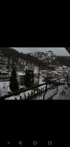 a group of sheep standing next to a fence in the snow at da Nicola e Greta in Miroglio